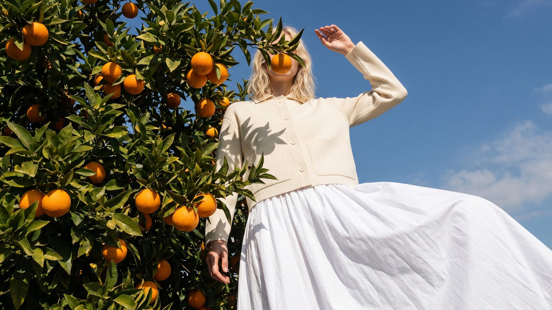 Model wearing Sheep Inc. knitwear in a sunlit landscape